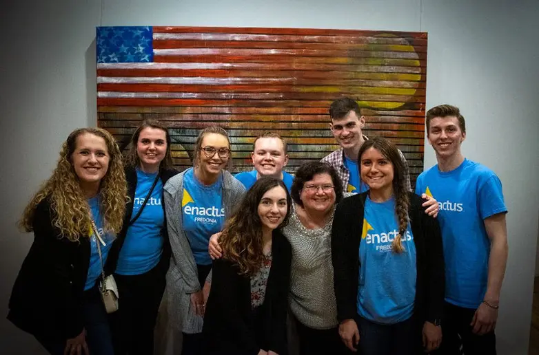 students in front of flag artwork