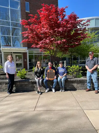 award winners in front of University Commons