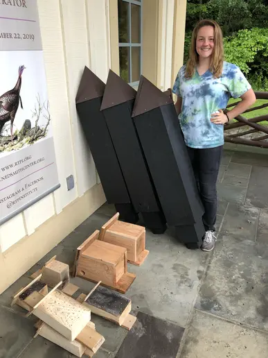 Jessica Schimek, with completed bee blocks, squirrel nests and bat houses