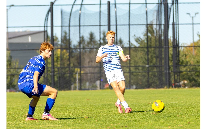 soccer players in action on the field by Travis Bernhard