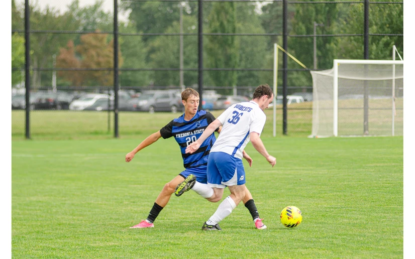 men playing soccer by Riley Olson