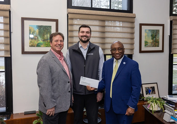 Southern Chautauqua Federal Credit Union CEO John Felton, Southern Chautauqua FCU Chief Financial Officer Matthew Hoaglund, ’21, and SUNY Fredonia President Dr. Stephen H. Kolison Jr. holding check