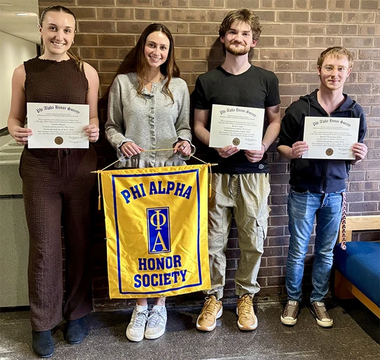 social work students standing with honor society banner and holding certificates