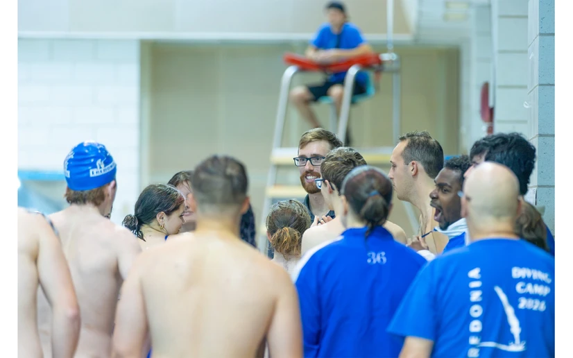 swimmers standing with coach by Travis Bernhard