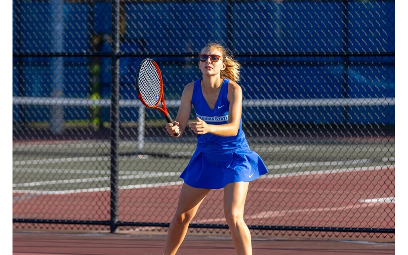 tennis player in action by Travis Bernhard