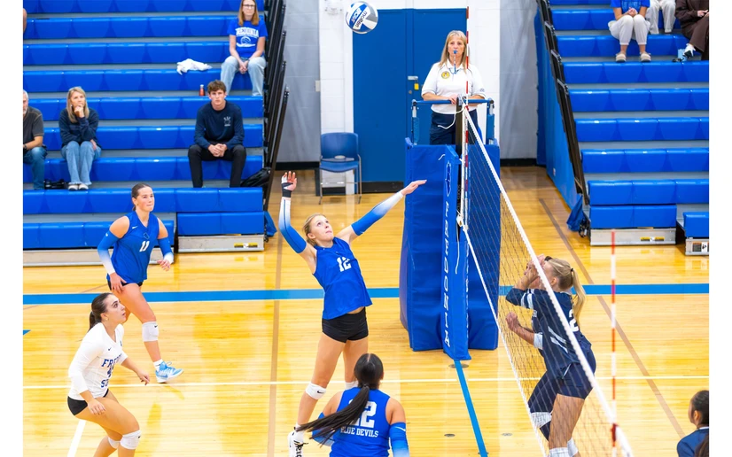 volleyball players in action by Travis Bernhard