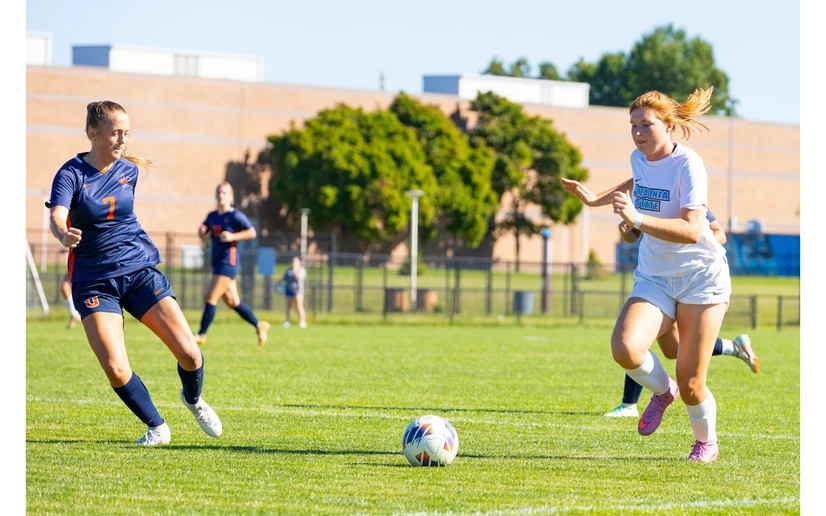 women playing soccer by Travis Bernhard