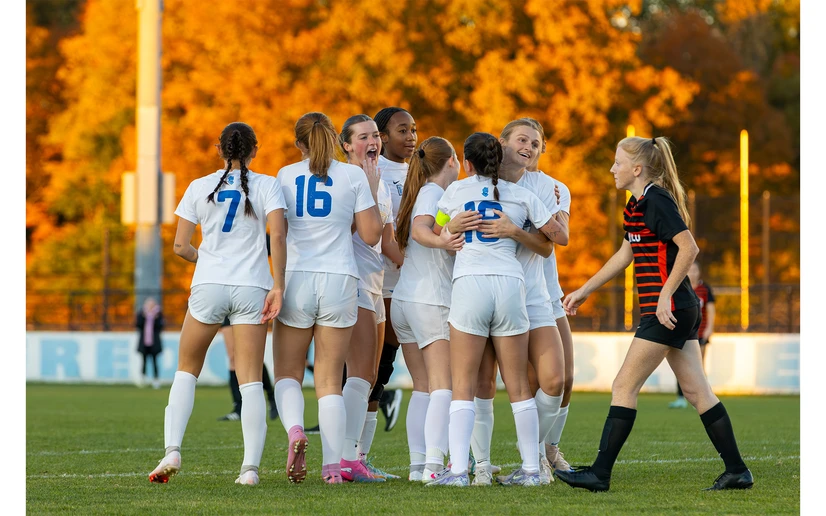 women soccer players celebrating on the field