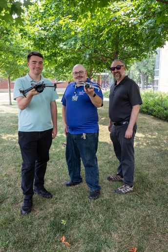 Information Technology Services staff (from left): Daniel LaGrow, Christopher Taverna and T. John McCune gave a demonstration on flying a drone. 