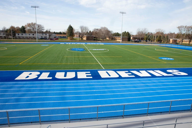 track and field faciltiy with running lanes in foreground and truf field behind