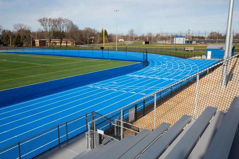 track and field faciltiy with running lanes in foreground and truf field behind