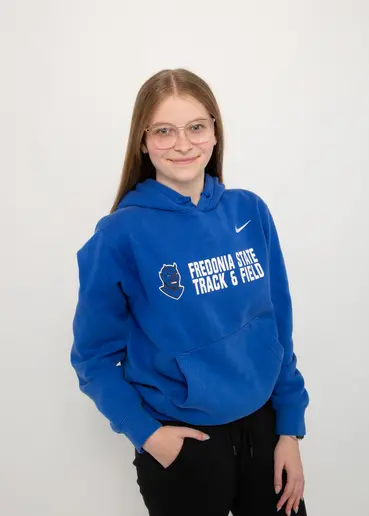 Student in the College of Liberal Arts and Sciences Hayley Mercer in their Fredonia hoodie