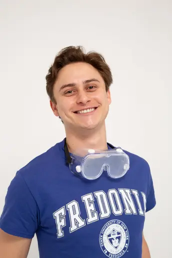 Fredonia student Hunter Burczyk smiling wearing goggles