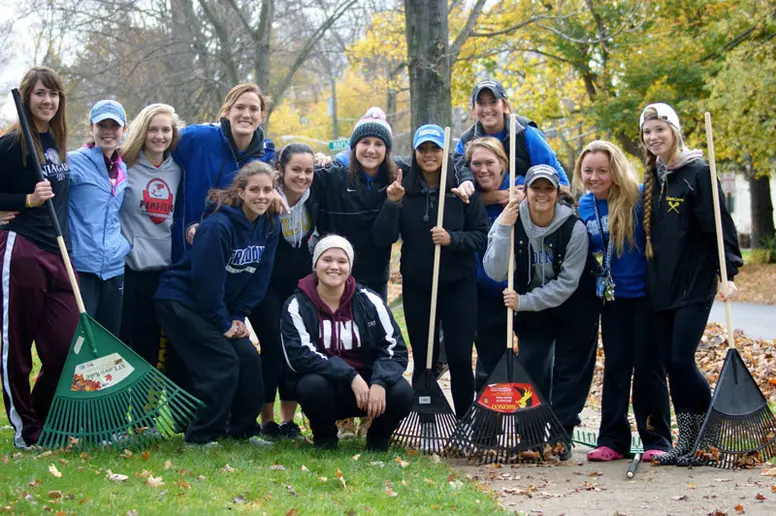 student raking leaves
