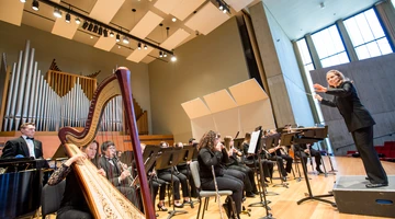 Fredonia wind ensemble students performing in the Rockefeller 
