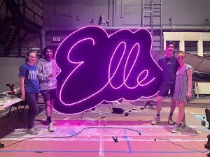 students in scene shop with item created for show