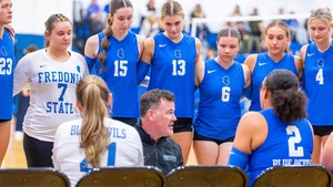 Coach Braun coaching surrounded by team members