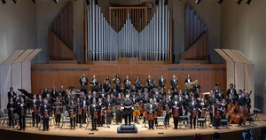members of the College Symphony standing on the King Concert Hall stage