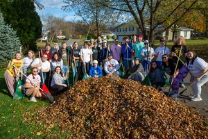 students in a group with rakes