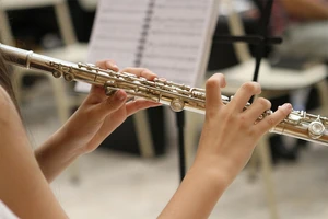 student playing the flute