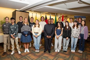international students posing with President Stephen H. Kolison Jr.