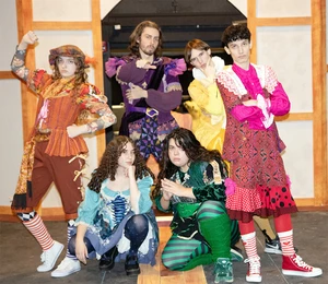 members of the cast in costume