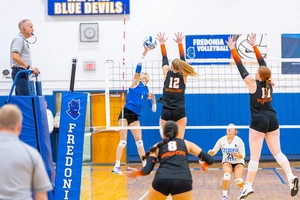volleyball players in action on the court in the Dods Hall gym