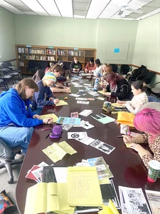 Students work on their own projects while listening to Riot Grrrl bands at a recent Friday Forum on Zines in anticipation of SUNY Fredonia's inaugural zine fest.