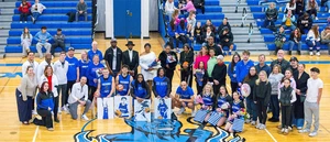 basketball and cheer squad with families in gymnasium