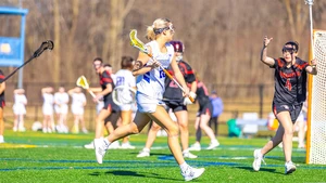 lacrosse players in action on the field