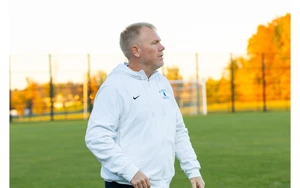 Coach Chris Case walking on the field
