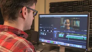 student working on video production