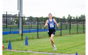 cross country runner in action by Riley Olson