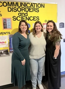 Hannah Belknap with two faculty members