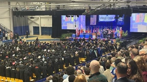 Steele Hall fieldhouse filled with guests and students for Commencement