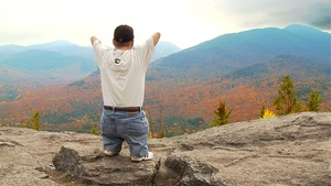 John Robinson of Our Ability standing on a mountaintop