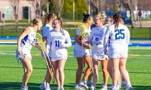 lacrosse players celebrating on field
