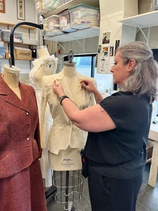 Costume Shop Supervisor Larissa McConnell working on a costume