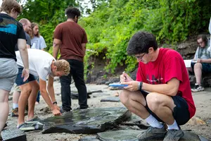 students conducting research on a stream