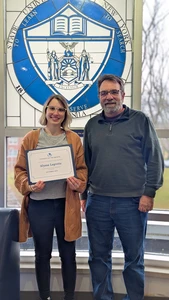 Alyssa LeGrette, holding her Student of the Month certificate, with Mark Mackey, of ITS.