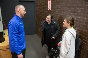 Scott Bergen talks to two students after a class talk he gave.