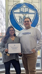 Ximena Ramirez Hernandez displays her Resident of the Month certificate, accompanied by Residence Director Ronny Nissen.