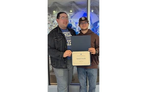former Student of the Month receiving his certificate