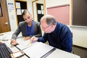Staff of the Henry C. Youngerman Center work with a client.