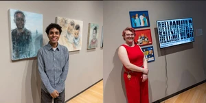 students standing next to their art work