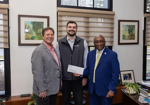 Southern Chautauqua Federal Credit Union CEO John Felton, Southern Chautauqua FCU Chief Financial Officer Matthew Hoaglund, ’21, and SUNY Fredonia President Dr. Stephen H. Kolison Jr. holding check