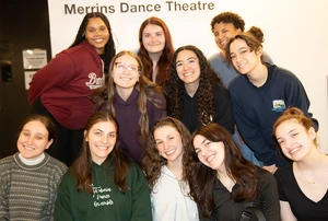 group of student dancers in front of Merrins Dance Theatre sign