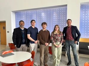 photo of returning alumni with faculty member