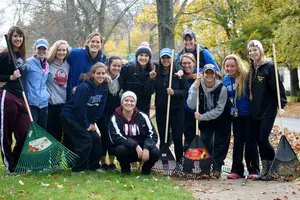 student raking leaves