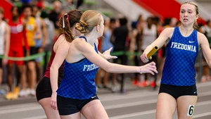 women competing on the track in relay